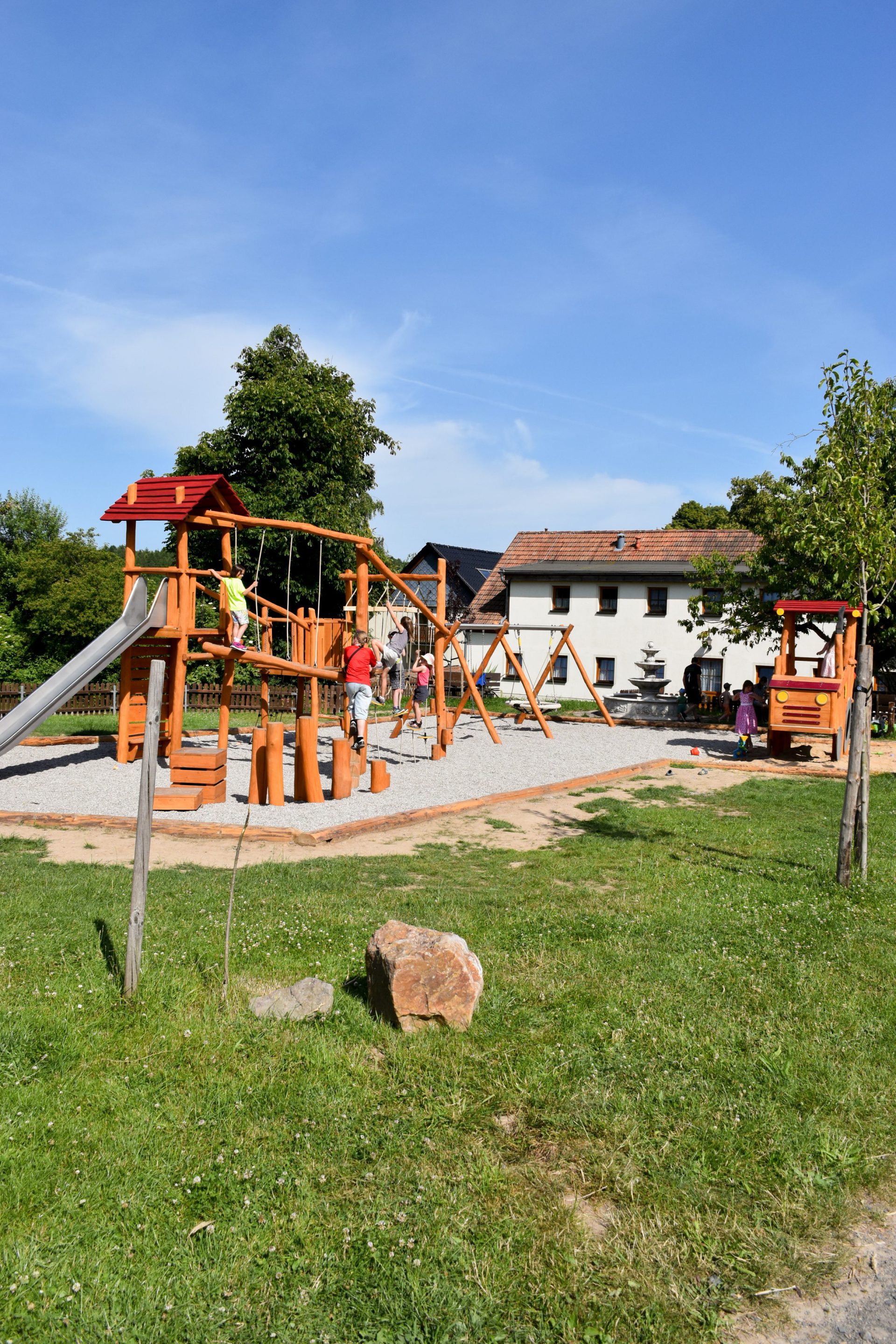 Spielplatz mit Klettergerüst und Schaukeln auf dem Hof