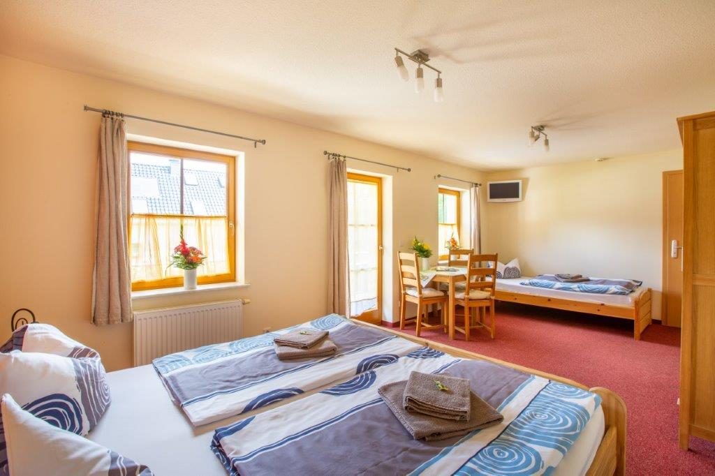 Doppelzimmer mit gemachten Betten und Sitzecke